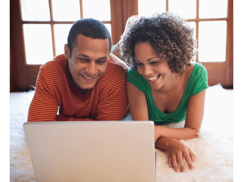 Couple looking at a laptop exploring online loan options