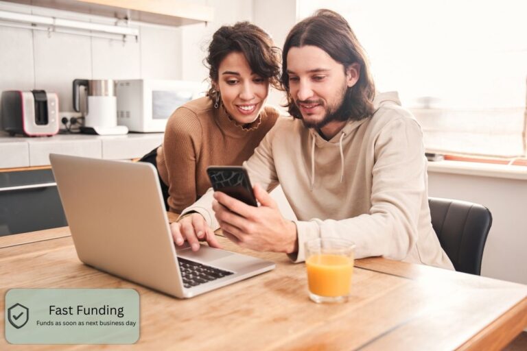 Couple reviewing personal loan options online using a laptop and smartphone